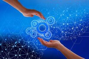 Hands interacting with digital gears representing digital economy.