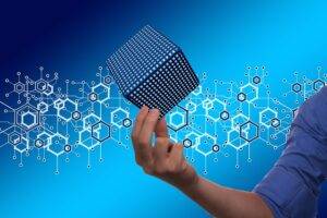 Hand holding a digital cube representing secure digital economy.